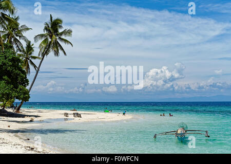 People Are Enjoying the Beach. A small family is enjoying the beach in Badian. There are few people around, you're free to visit Stock Photo