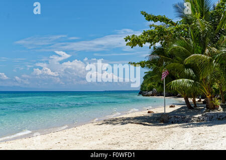 An American Flag on the Sea Shore. A beautiful beach in Badian island in Cebu. With many American tourists visiting the area, a