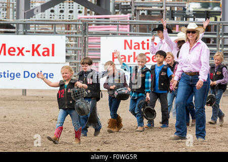 Estes Park, Colorado - Children ages 5-8 wave to the crowd after participating in the Mutton Bustin' (sheep riding) competition Stock Photo