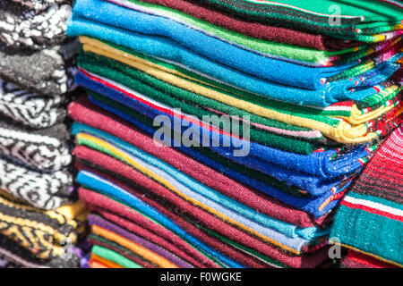 Colorful Mexican serapes hang in row.  Great for background Stock Photo