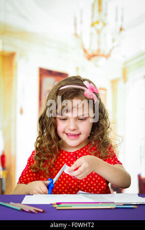 Sweet little girl using scissors Stock Photo