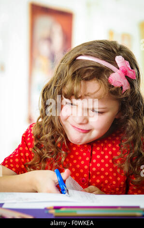 Sweet little girl using scissors Stock Photo