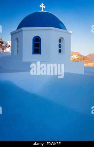 Iconic blue domed chapel in the town of Oia on the greek island Santorini (Thera) Stock Photo