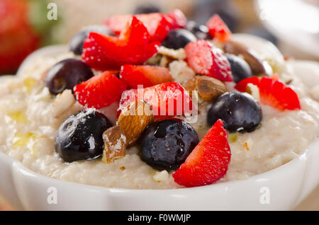 Oatmeal with fresh Berries and nuts  for  Breakfast. Selective Focus Stock Photo