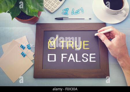 True or False checkboxes with True checked, sketched on a little black chalkboard Stock Photo