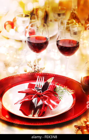 Red and gold themed holiday dinner table setting Stock Photo