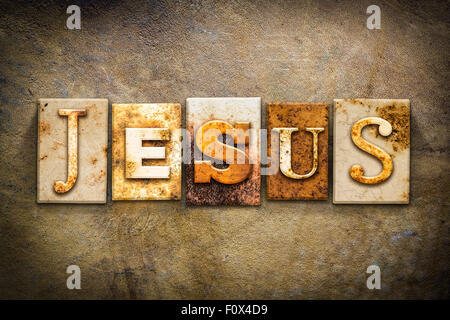 The name 'JESUS' written in rusty metal letterpress type on an old aged leather background. Stock Photo