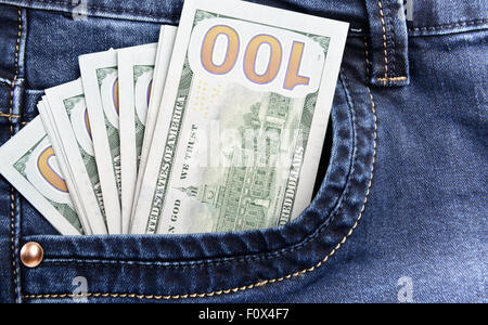 100 dollar bills money in pocket of blue jeans Stock Photo