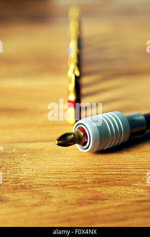 Screwdriver bit in holder with other bits behind. Stock Photo