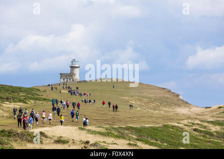 People walking towards Belle Tout lighthouse. The Seven Sisters Cliffs, South Down National Park, East Sussex, UK Stock Photo