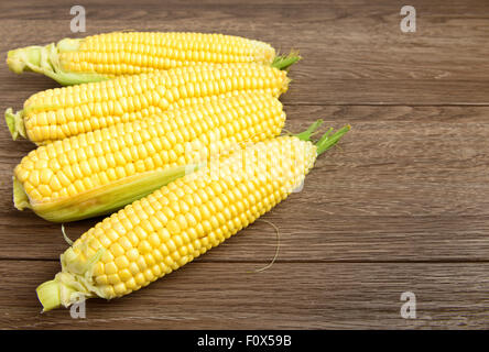 Fresh raw corn on wooden table Stock Photo