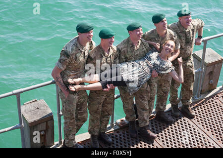 Bournemouth, UK. 22 August 2015. Woman enjoying being lifted by Royal Marines Commando commandos on Bournemouth Pier during Bournemouth Air Festival Credit:  Carolyn Jenkins/Alamy Live News Stock Photo