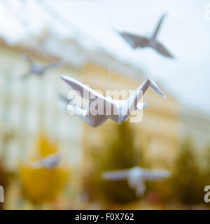 Origami crane flying in the city - street art Stock Photo