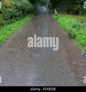 Herefordshire UK. 22nd August, 2015. After a day of very hot and humid weather a summer thunderstorm brought torrential rain down at Titley Herefordshire at 6.15pm causing flooding on many country lanes that lack drains. Stock Photo