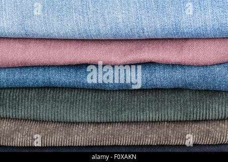 stack of different denims and corduroys close up Stock Photo