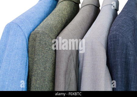 set of finished jackets on hangers in close up isolated on white background Stock Photo