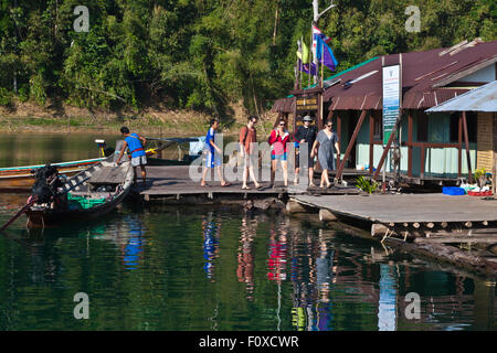 Guests arrive at TAM GIA RAFT HOUSE on CHEOW EN LAKE in KHAO SOK NATIONAL PARK - THAILAND Stock Photo