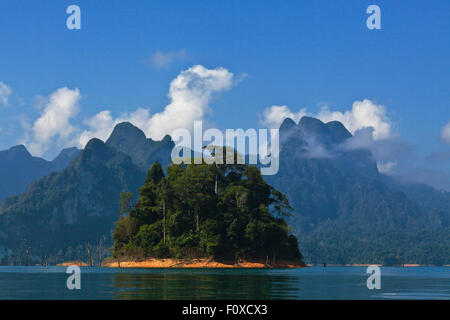 KARST FORMATIONS covered with tropical jungle surround CHEOW EN LAKE in KHAO SOK NATIONAL PARK - THAILAND Stock Photo