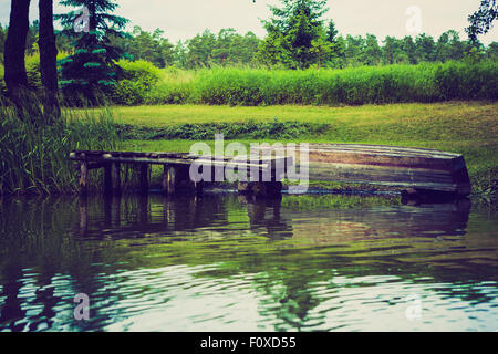 Vintage photo of beautiful Krutynia river landscape photographed from kayak. Photo with vintage mood effect Stock Photo