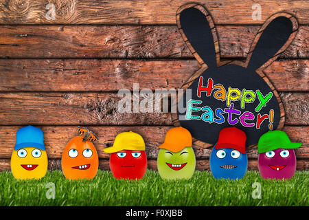 funny eater eggs in front of wooden easter background Stock Photo