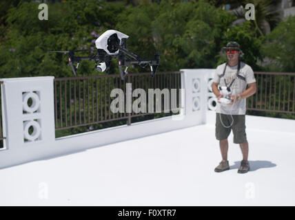 Man controlling DJI Inspire Drone quadcopter a  commercial and recreational unmanned aerial vehicle for aerial photography Stock Photo