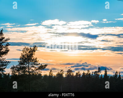 Beautiful autumn forest and clouds at sunset Stock Photo