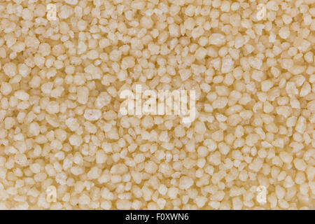 Background of heap of couscous, viewed from above. Stock Photo