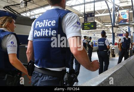 Brussels. 23rd Aug, 2015. Police officers stand on the platform at the Zuid-Midi railway station in Brussels, on August 23, 2015. Belgium decided to step up patrols in trains and stations, a day after a Kalashnikov-wielding man's attack on a high-speed Amsterdam to Paris train was foiled, official sources said Saturday. A shooting happened Friday in a Thalys train between Paris and Amsterdam, injuring three people. The suspect boarded from Brussels Midi station, according to the French intelligence services. Credit:  Xinhua Photo/Gong Bing/Xinhua/Alamy Live News Stock Photo