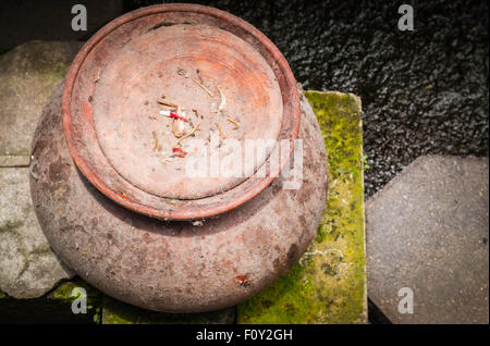 The old clay pot left on the brick floor in top view. Stock Photo