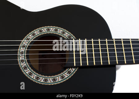 Detail of Black Wooden Classical Acoustic Guitar Isolated on a White Background Stock Photo