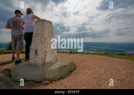 Two people enjoying the View from the top of the Wrekin Hill in Telford Shropshire UK
