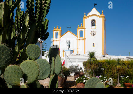 Praia da Luz church of Nossa Senhora da Luz Our Lady of Light with cactus plant in foreground Algarve Portugal Stock Photo