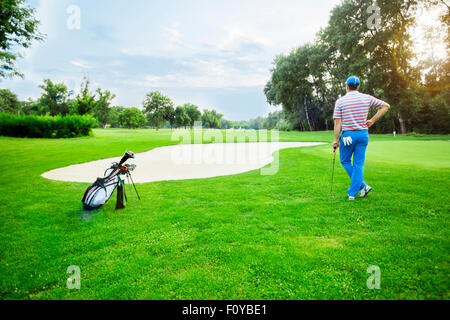 beautiful scenery with a golfer, course, sunset landscape Stock Photo