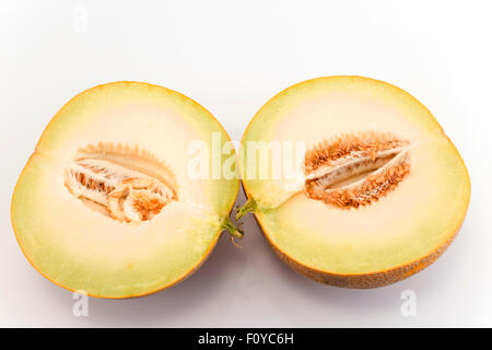 Melon cut in half isolated on white Stock Photo