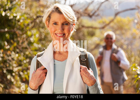 beautiful senior woman hiking in the mountain with husband Stock Photo