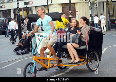 London, UK, 21/08/2015, Pedicab rickshaw with passengers in Covent Garden in the West End of London. Stock Photo