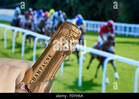 CHAMPAGNE HORSE RACES ASCOT RACING Luxury Champagne in ice bucket with Ladies Day Royal Ascot horse racing in background Ascot Berkshire UK Stock Photo