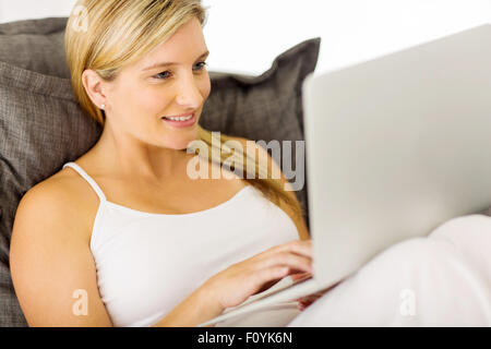 gorgeous young pregnant woman using laptop computer at home Stock Photo