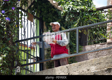 Mailman delivering mail n the hills of Valparaiso, Chile Stock Photo