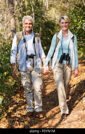 cheerful middle aged couple hiking outdoors in the mountain Stock Photo