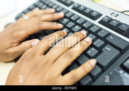 hands on a computer keyboard Stock Photo