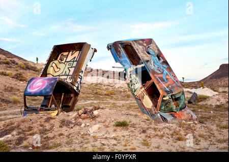 Junk cars artistically buried in the desert near Goldfield Nevada in the Place known as the 'Car Graveyard' Stock Photo
