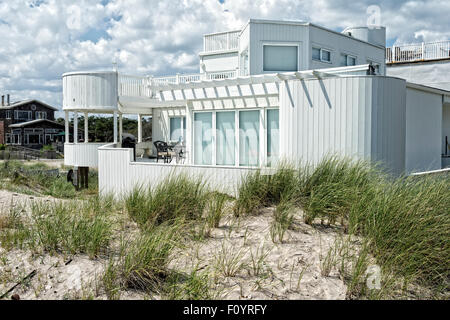 Partial view of a beautiful white modern large home, beachside, Ocean Beach, Fire Island, Long Island, New York.  A seaside reso Stock Photo
