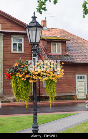 Street lamp in front of the old wooden house on rainy day Stock Photo