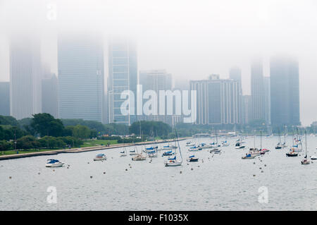 Tops of skyscrapers on Lakeshore Drive in Chicago shrouded in mist rolling in off Lake Michigan. Stock Photo