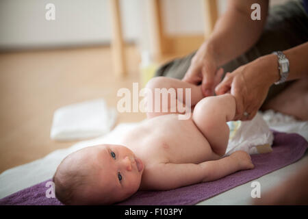 INFANT BEING MASSAGED Stock Photo