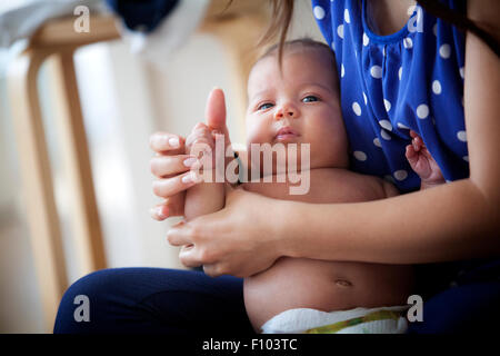 INFANT BEING MASSAGED Stock Photo