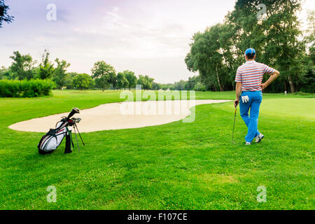 beautiful scenery with a golfer, course, sunset landscape Stock Photo