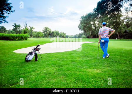 beautiful scenery with a golfer, course, sunset landscape Stock Photo