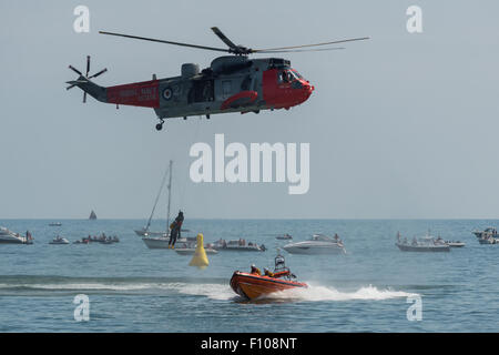 Royal Navy Sea King rescue demonstration with the RNLI at the Dawlish Air Show 2015 in its last year of active service. Stock Photo